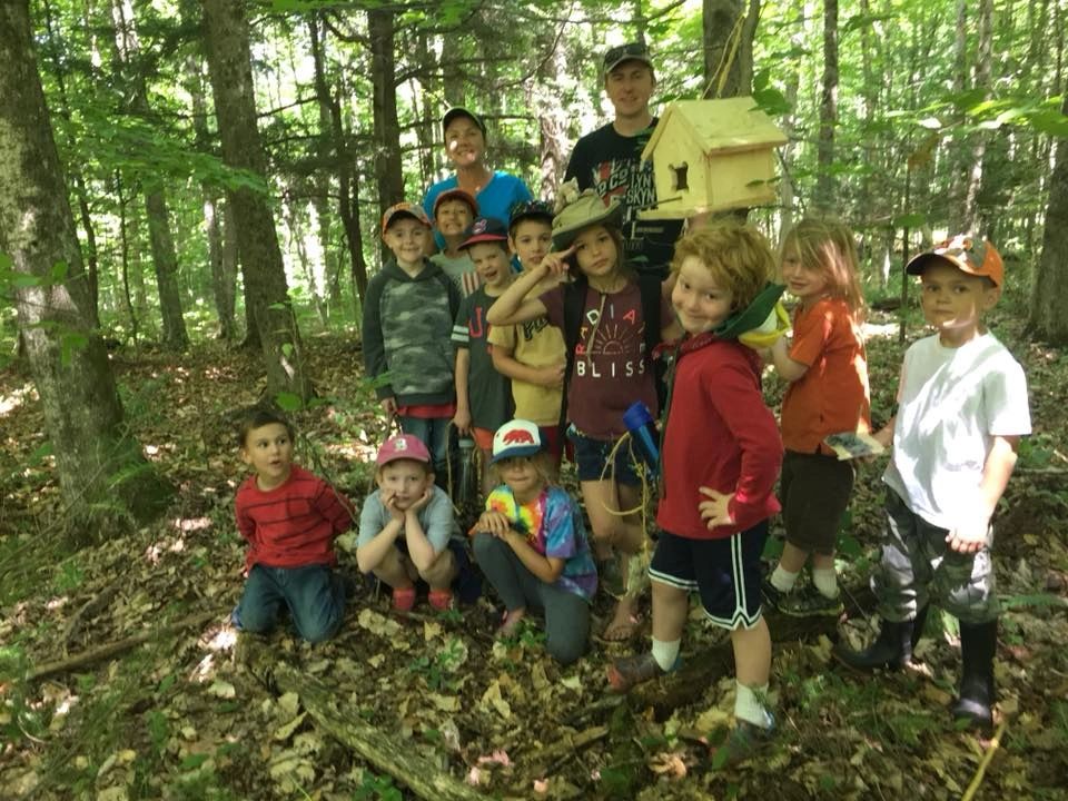 Children and educators gathered together in a Vermont forest