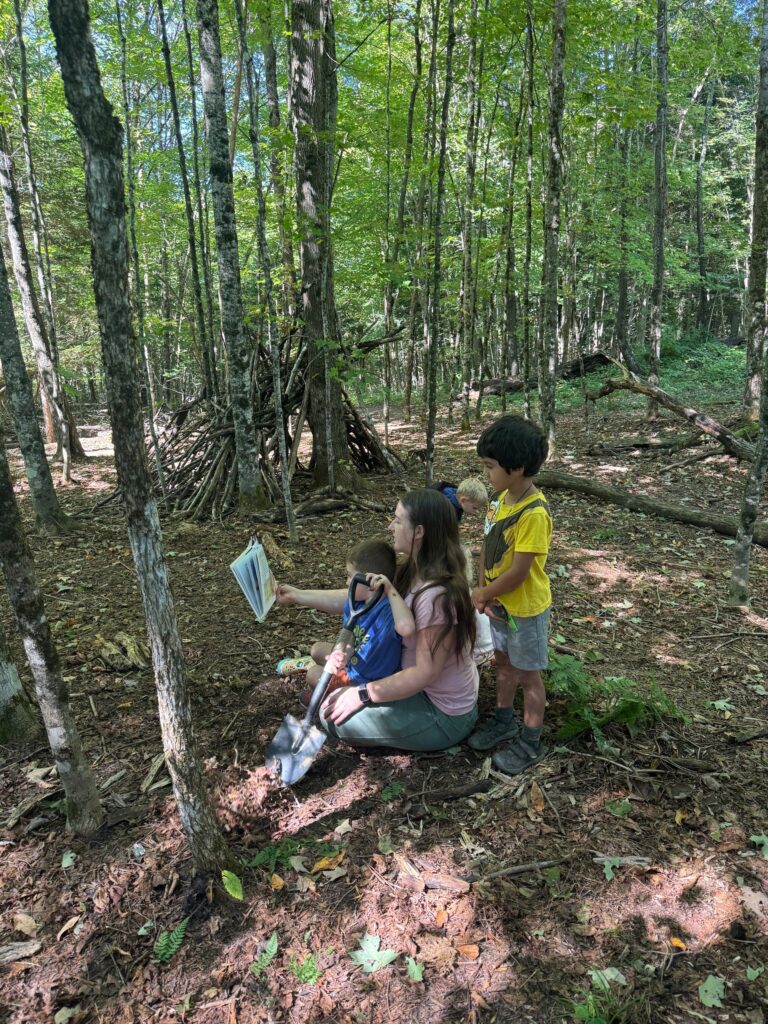 Children exploring and learning together outdoors in a Vermont forest at Field, Farm & Forest